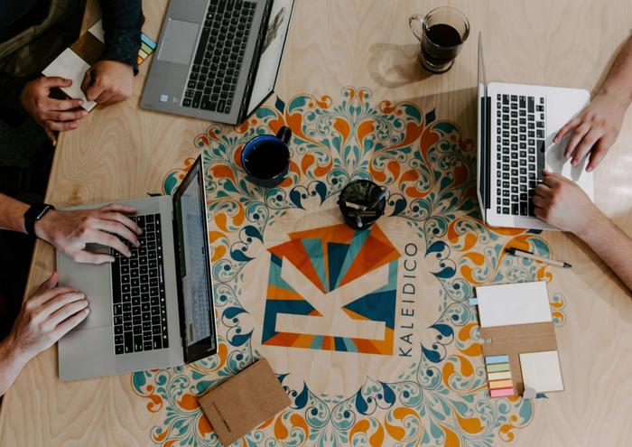 three laptops on a table
