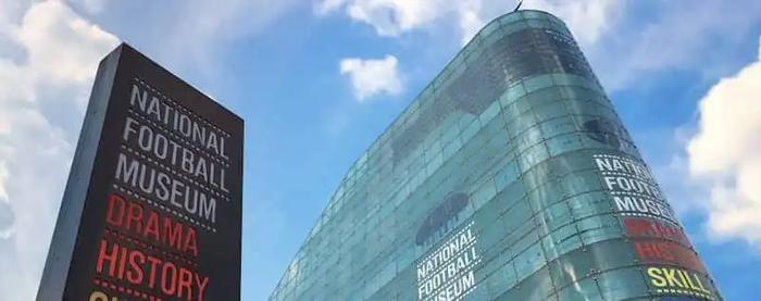 a large building with a sign in front of it that says national football museum .