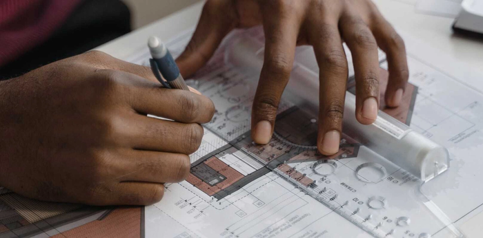 An architect working on blueprints