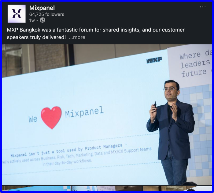 A man stands in front of a screen that says Mixpanel.