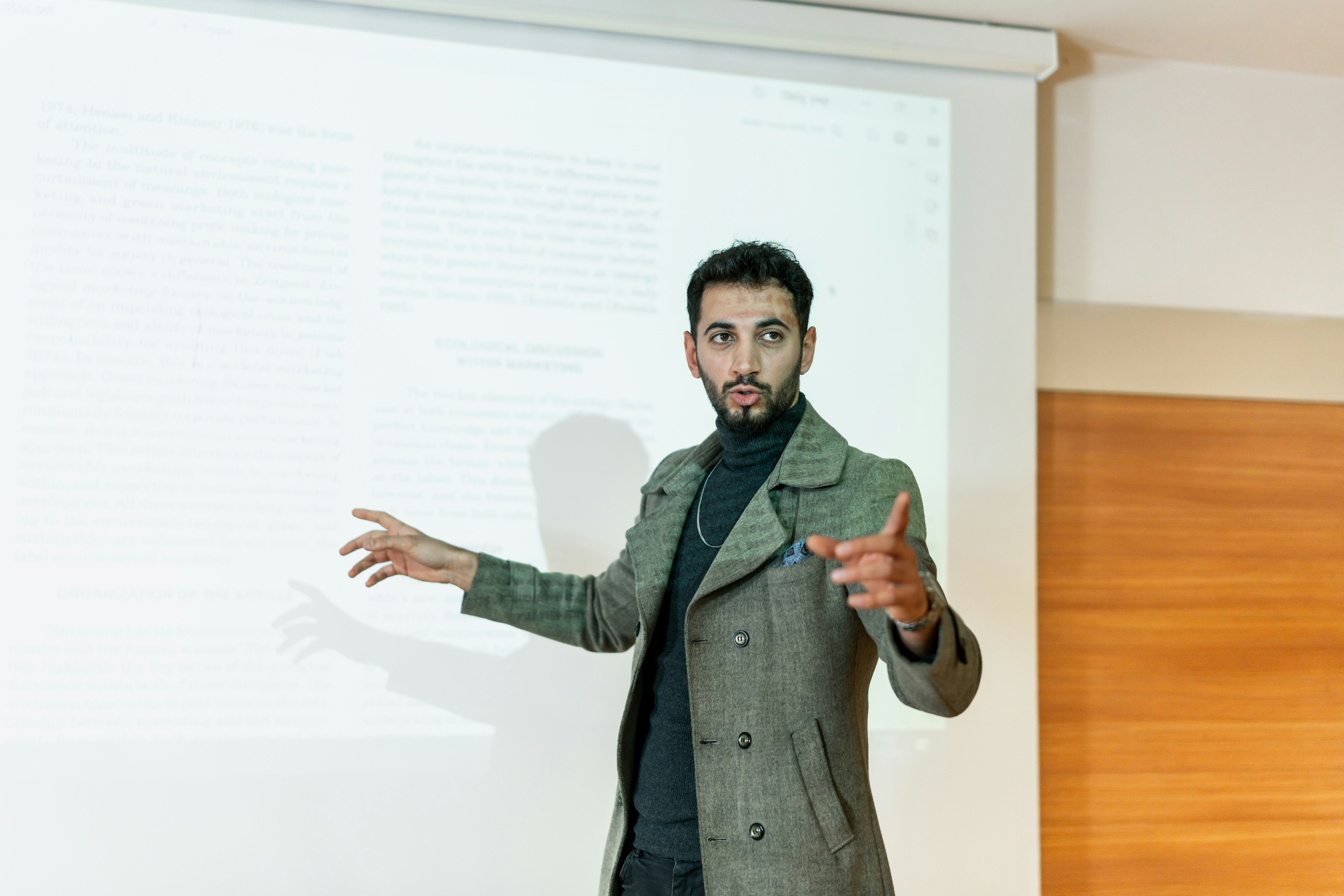 Man giving a presentation in front of a projected screen.