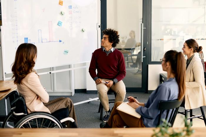 four people having a meeting