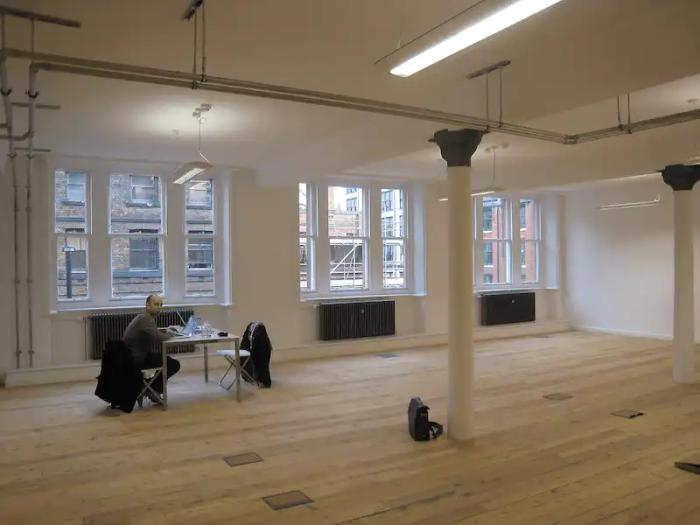 Duncan sitting at the only desk in a big empty office