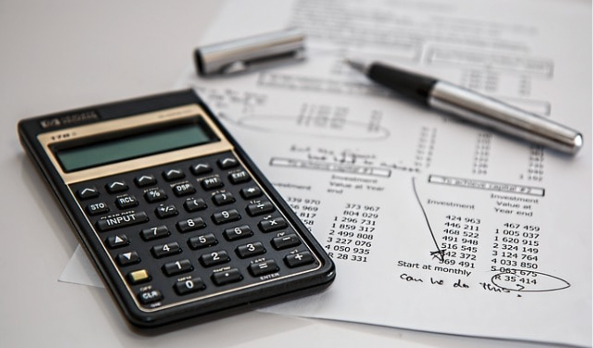 a calculator sits on top of a sheet of paper with numbers on it