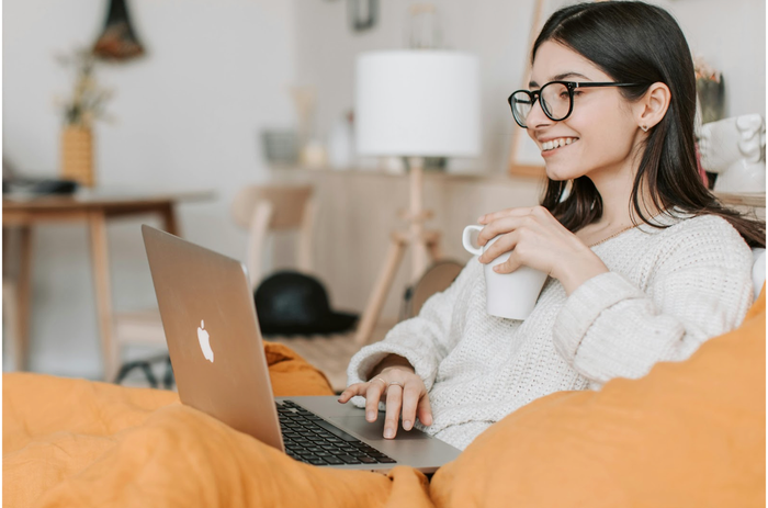drinking a coffee while using a laptop