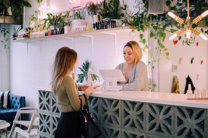 a woman is standing at a bar
