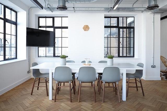 A conference room with a long table and chairs.