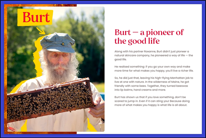 A man with a beard is holding a beehive.