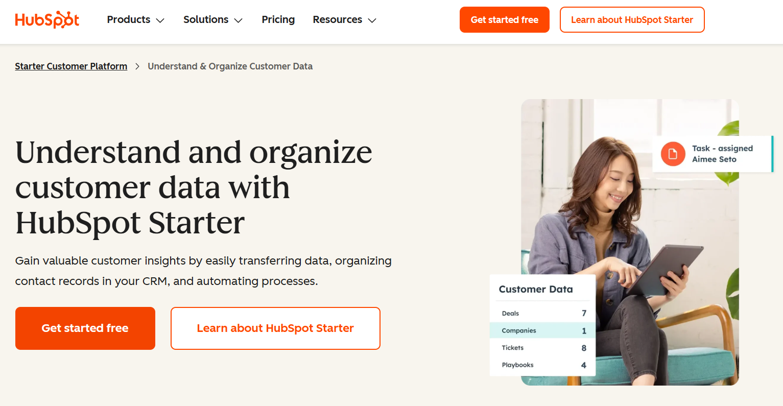 HubSpot webpage: "Understand and organize customer data with HubSpot Starter," featuring a smiling woman using a tablet with a customer data summary overlay.