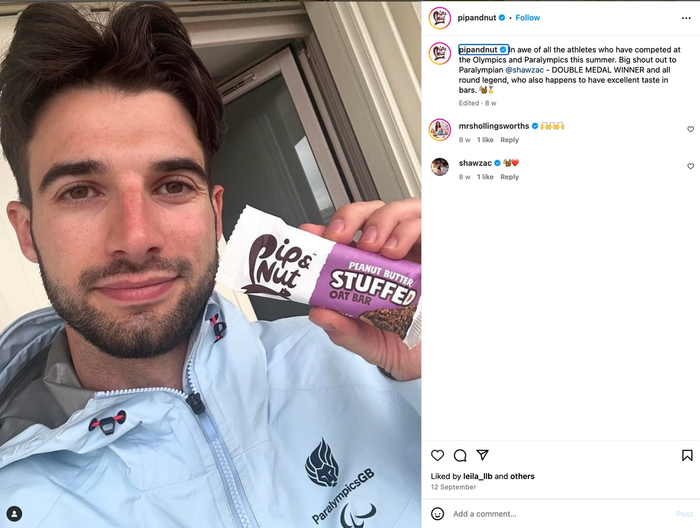 a man is holding a peanut butter stuffed cat bar