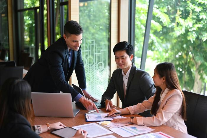 a group of business people are having a meeting in an office .