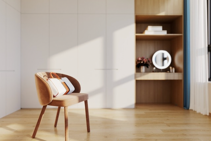 an empty room with a chair and a mirror