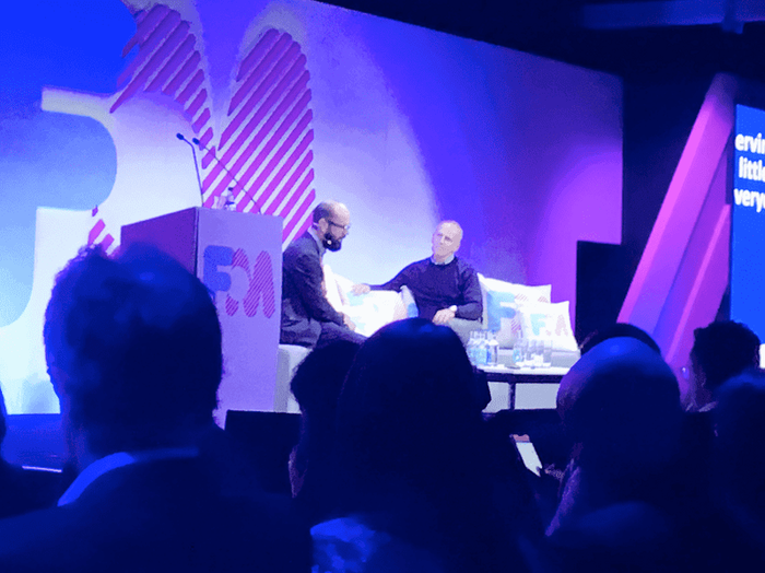 two men are sitting in front of a podium that says fm
