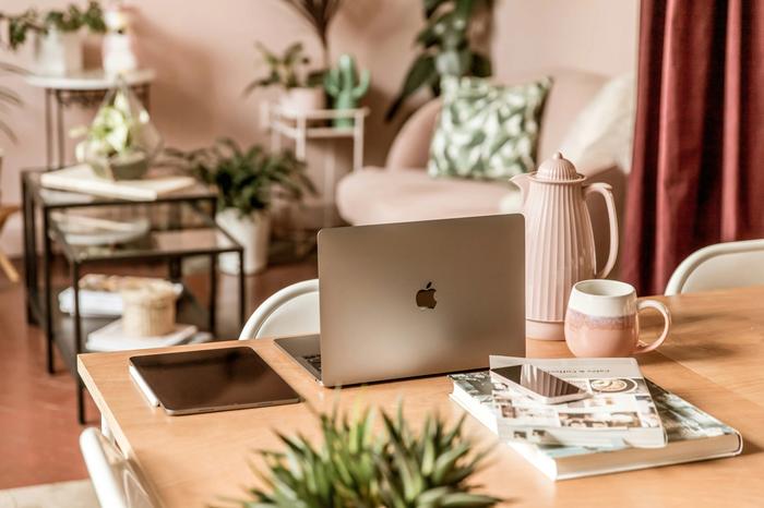 a laptop computer is sitting on a wooden table in a living room .