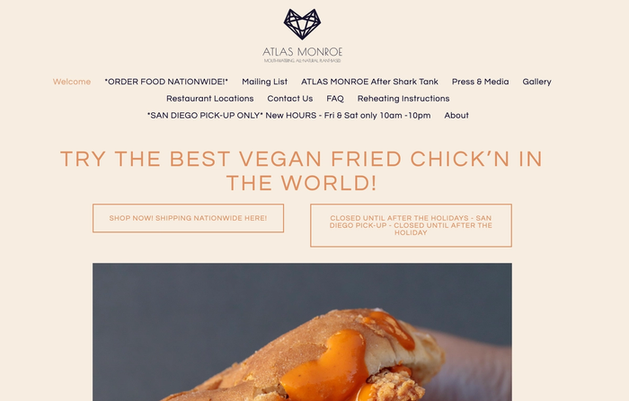 the website for atlas monroe shows a picture of a fried chicken sandwich