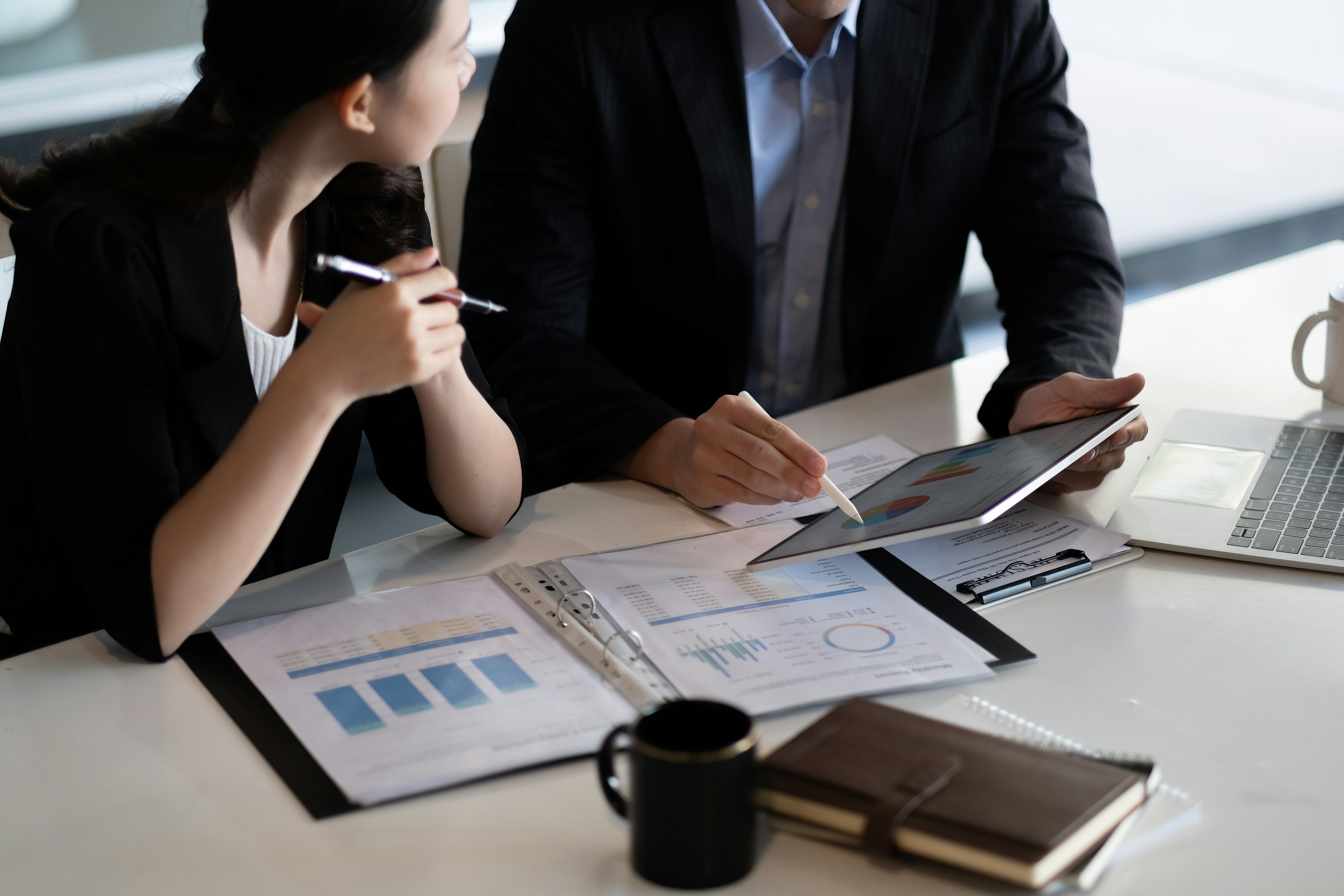 two people looking at graphs