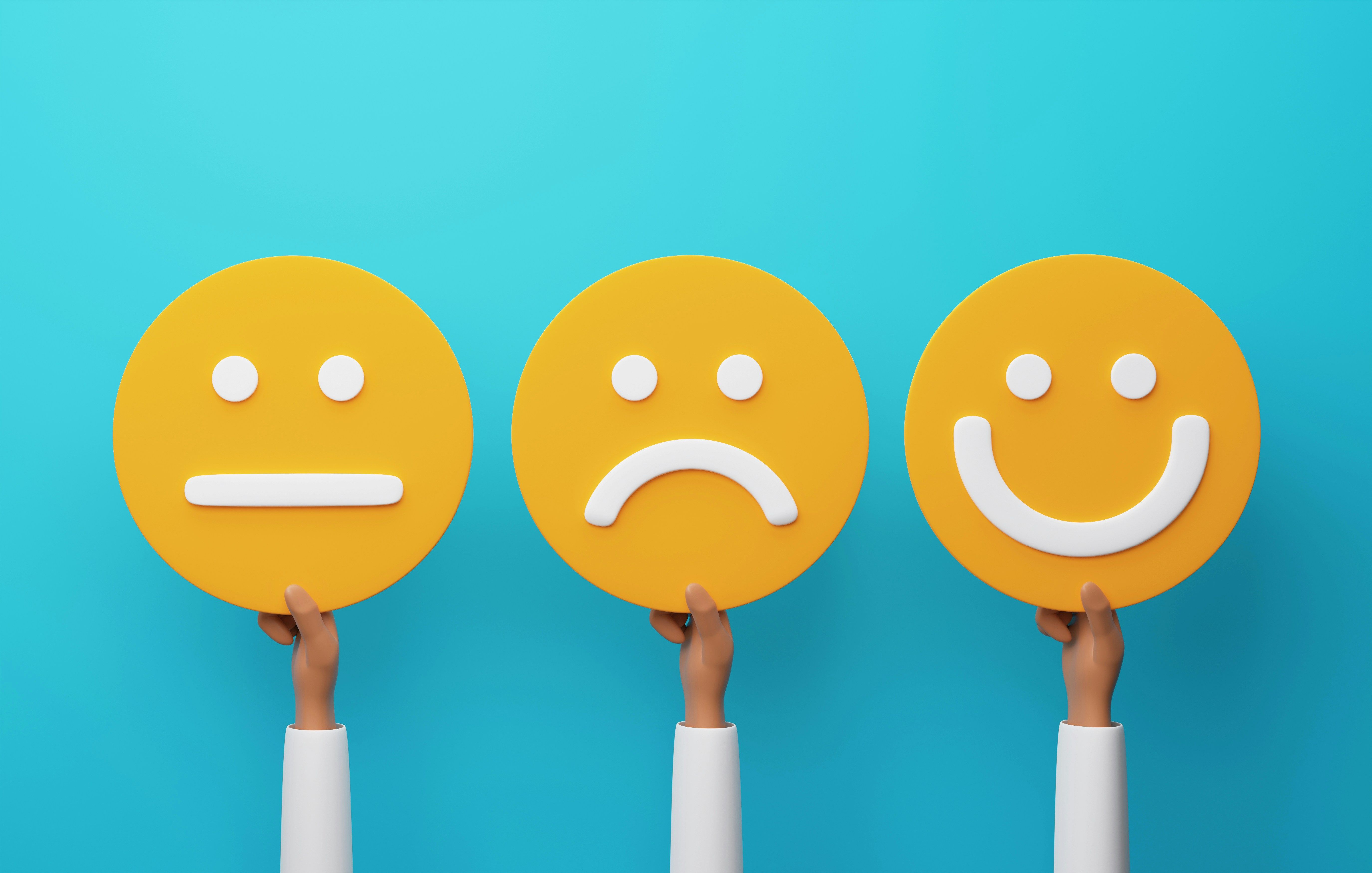 Hands holding yellow emoji faces: neutral, sad, and happy.