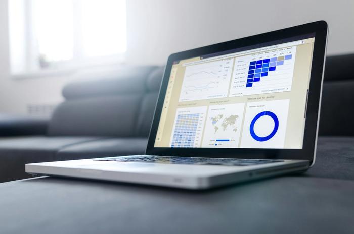a laptop computer is sitting on a table with a dashboard on the screen .
