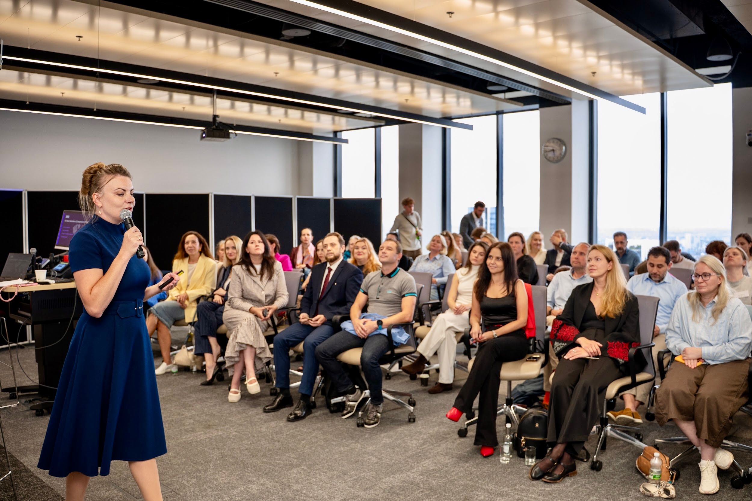 Nataliia Hrytsiuk speaks at The Next Generation of Entrepreneurs for Ukraine event at UCL School of Management, with Ukrainian and international participants seated in the audience.