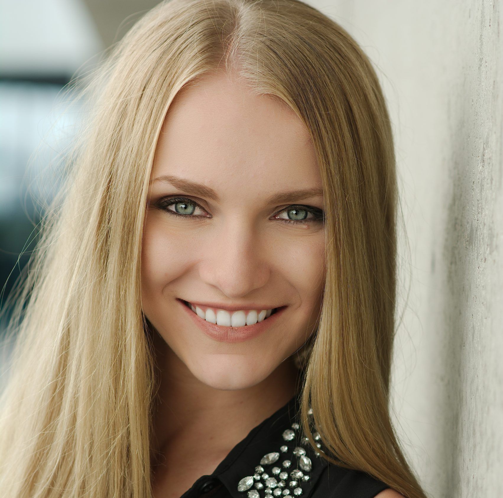 Woman with long blonde hair smiling at the camera