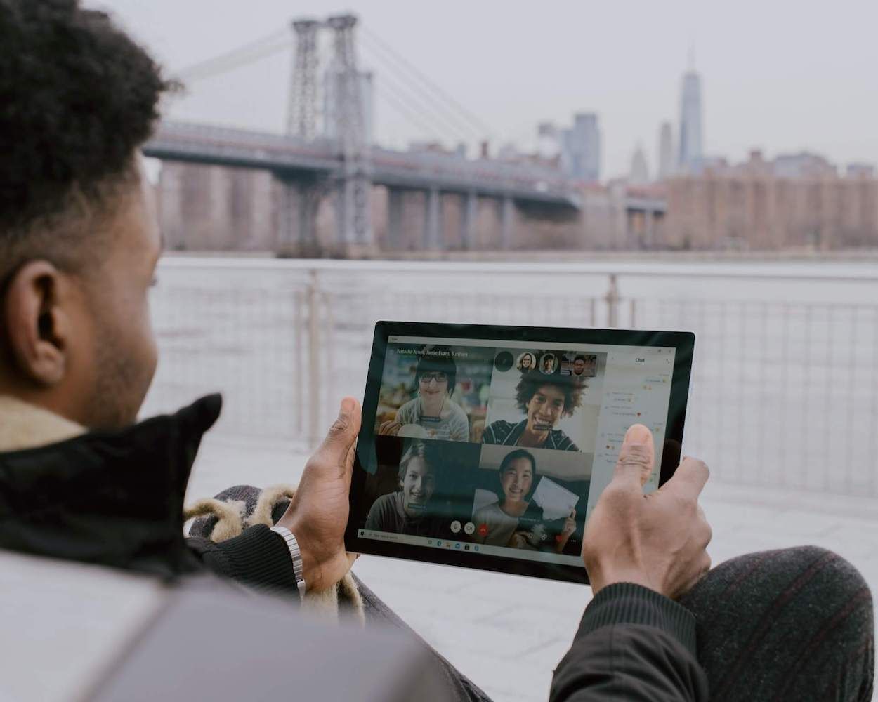Man joins a group video call on a tablet outdoors