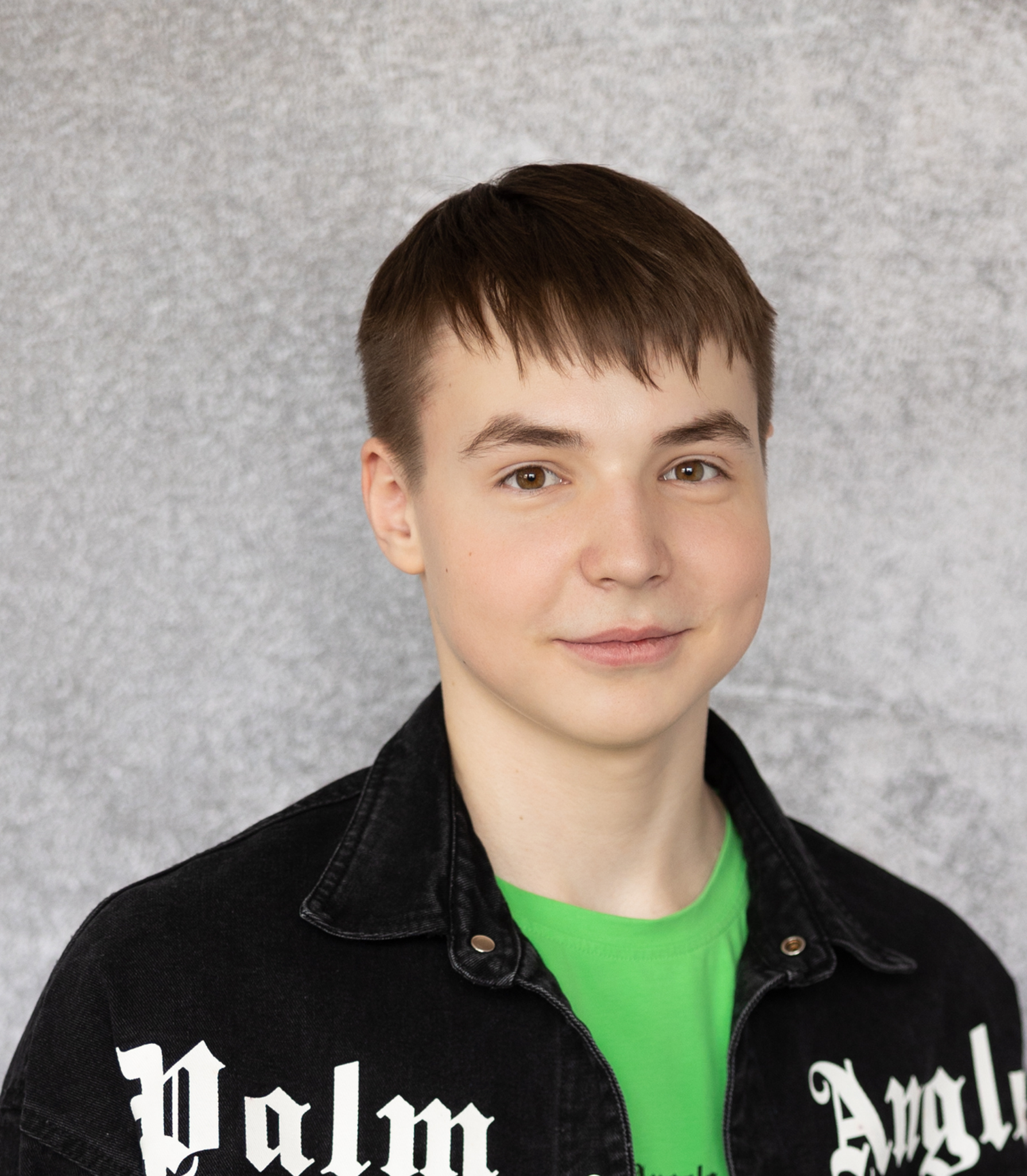 Young man in a black jacket facing the camera