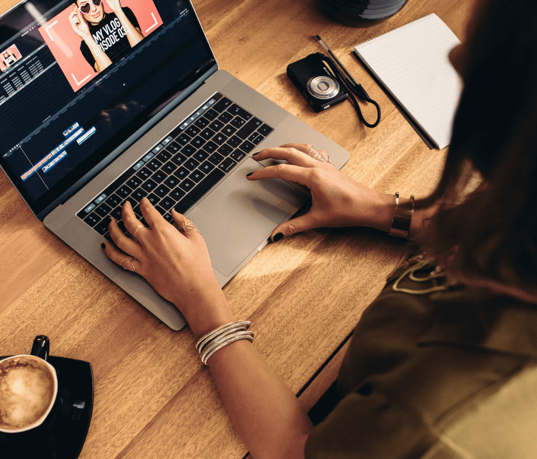 Person editing a vlog video on a laptop