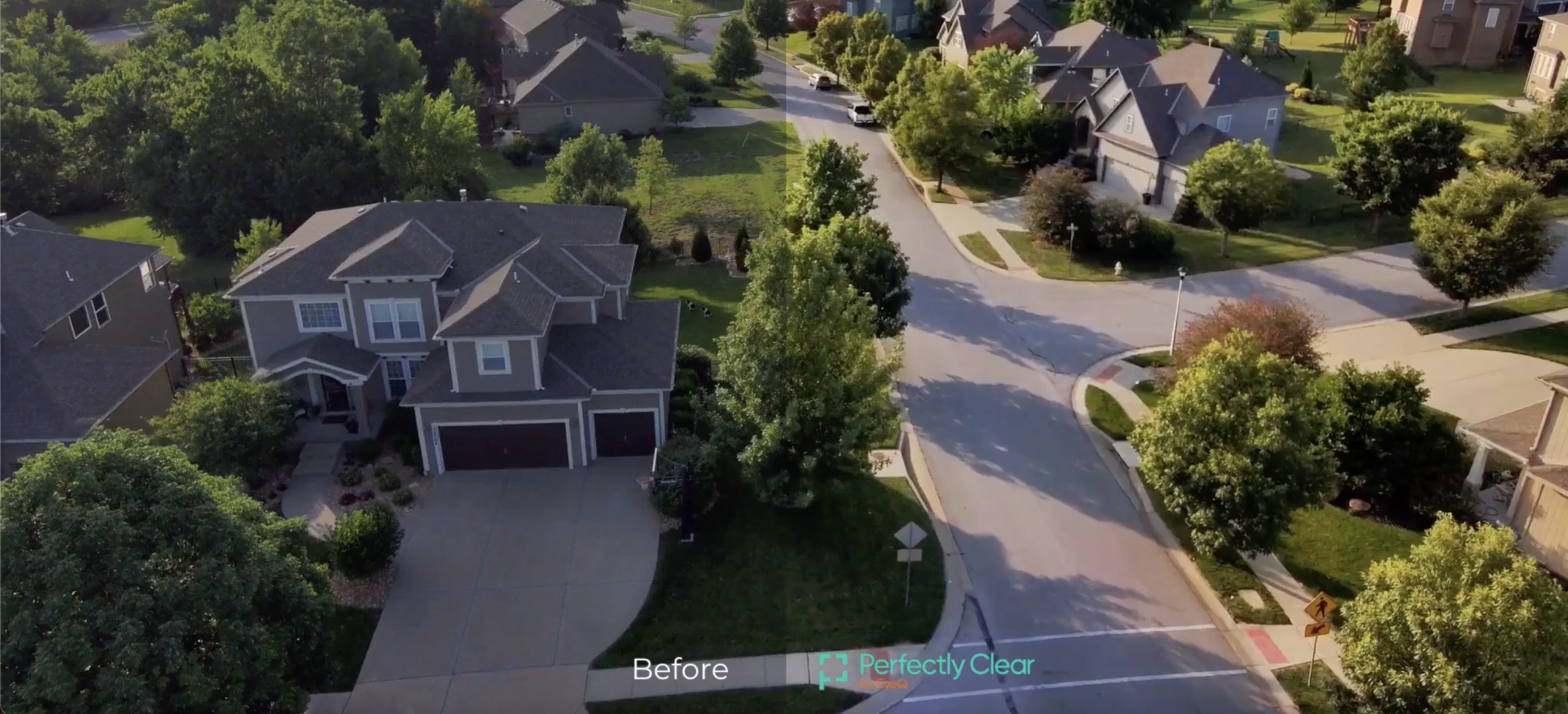Aerial view of suburban homes and a tree-lined intersection