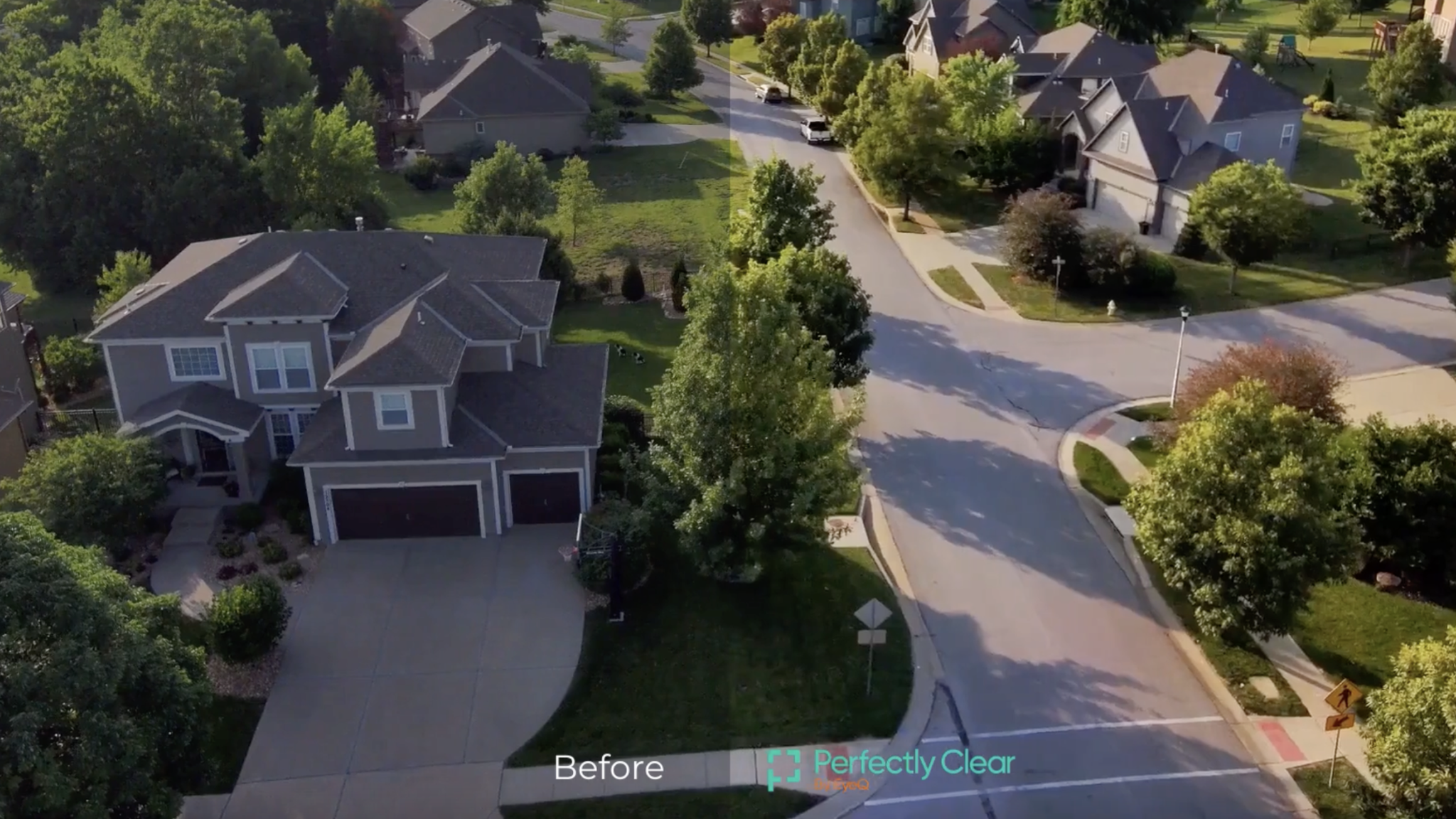 Aerial view of suburban homes and a tree-lined intersection
