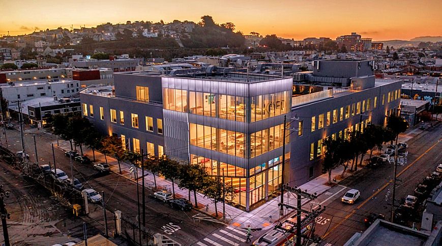 Modern office building at a city intersection at sunset