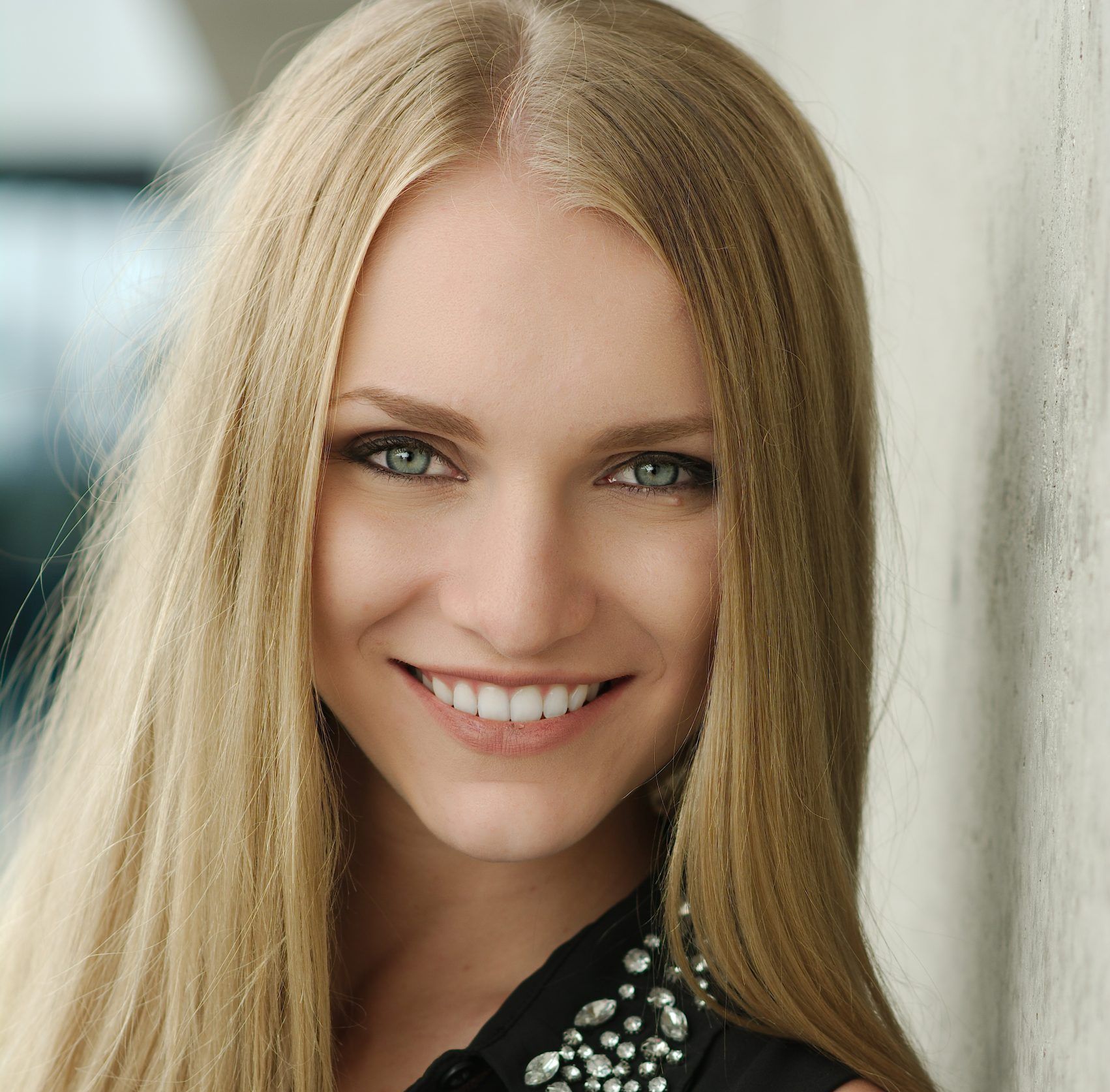 Woman with long blonde hair smiling at the camera