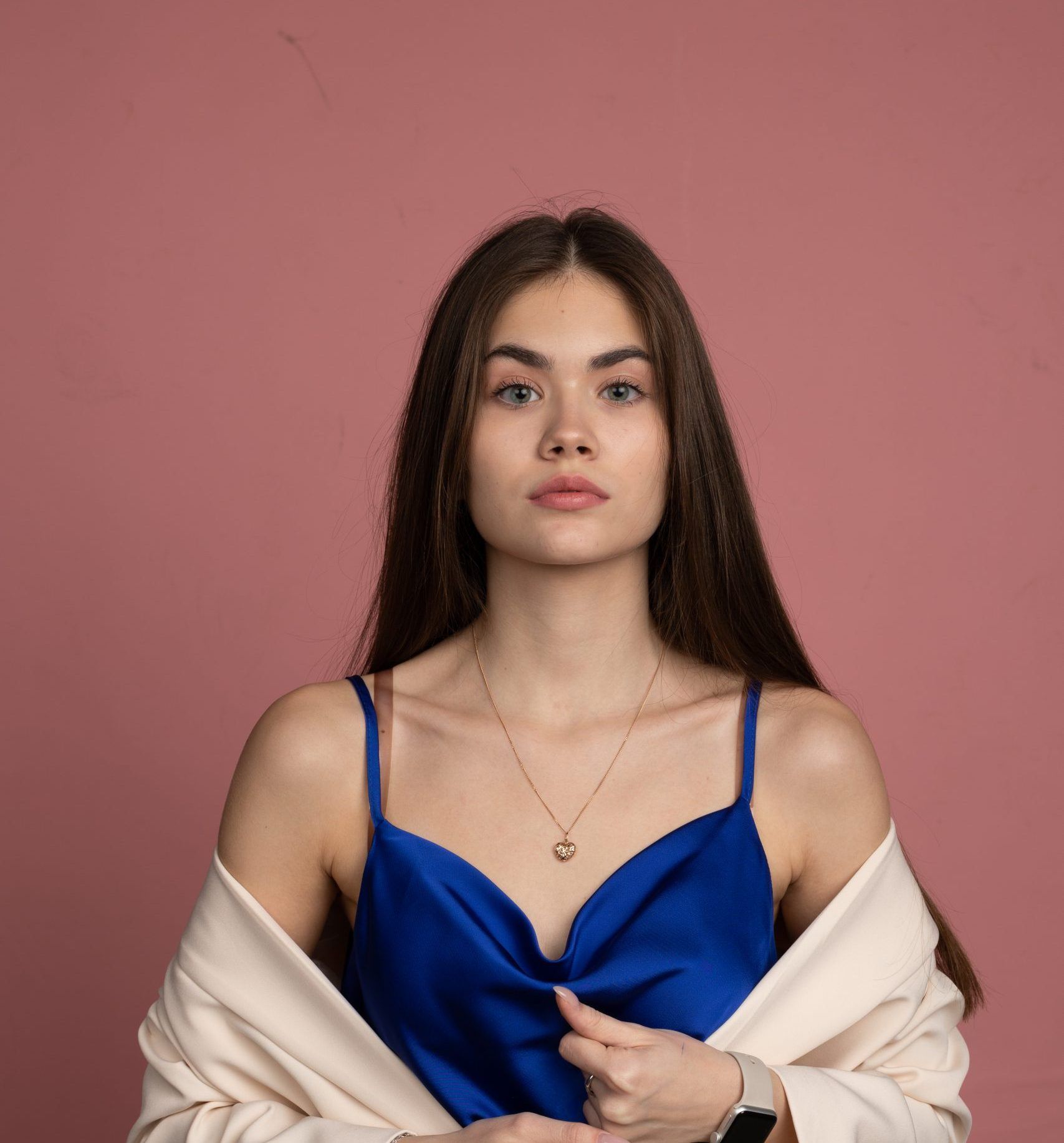Woman in a blue dress and shawl facing the camera