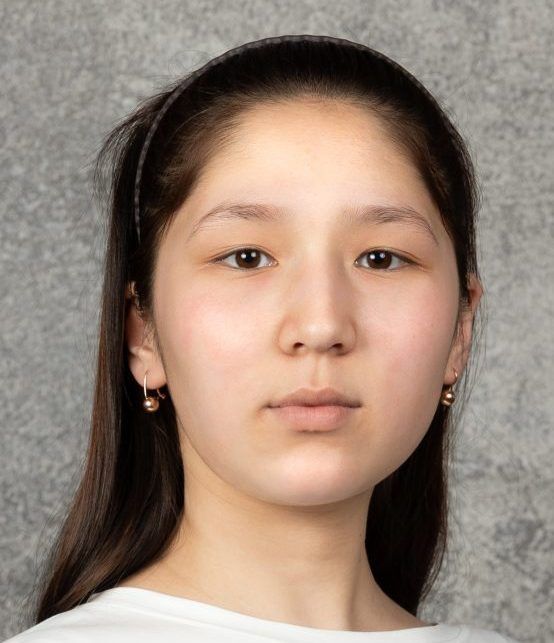 Young woman with dark hair facing the camera