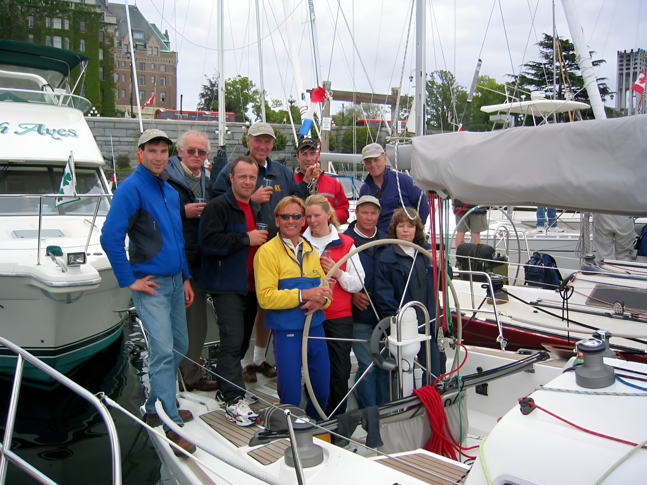 Sailing crew gathers aboard a docked sailboat