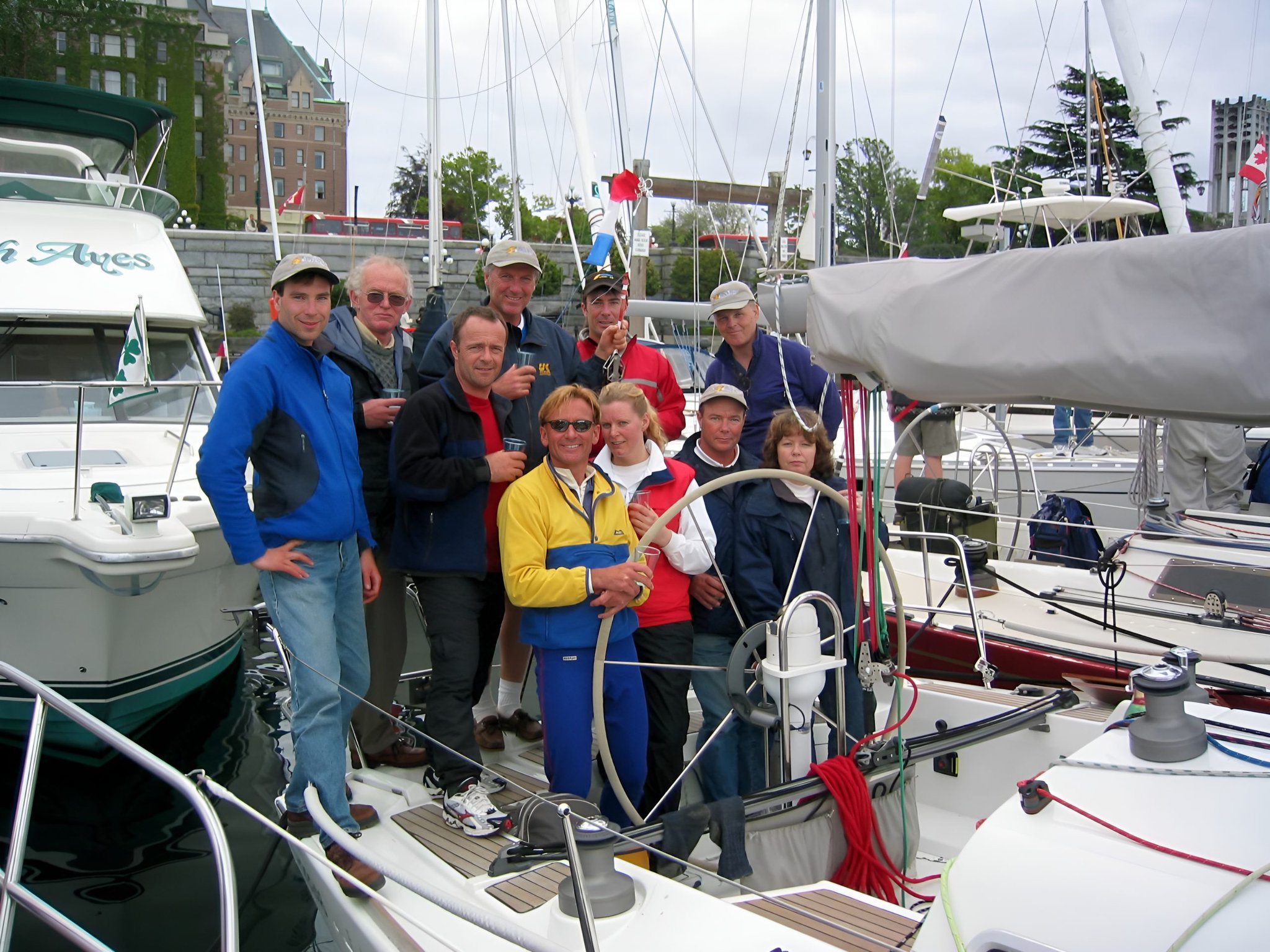 Sailing crew gathers aboard a docked sailboat