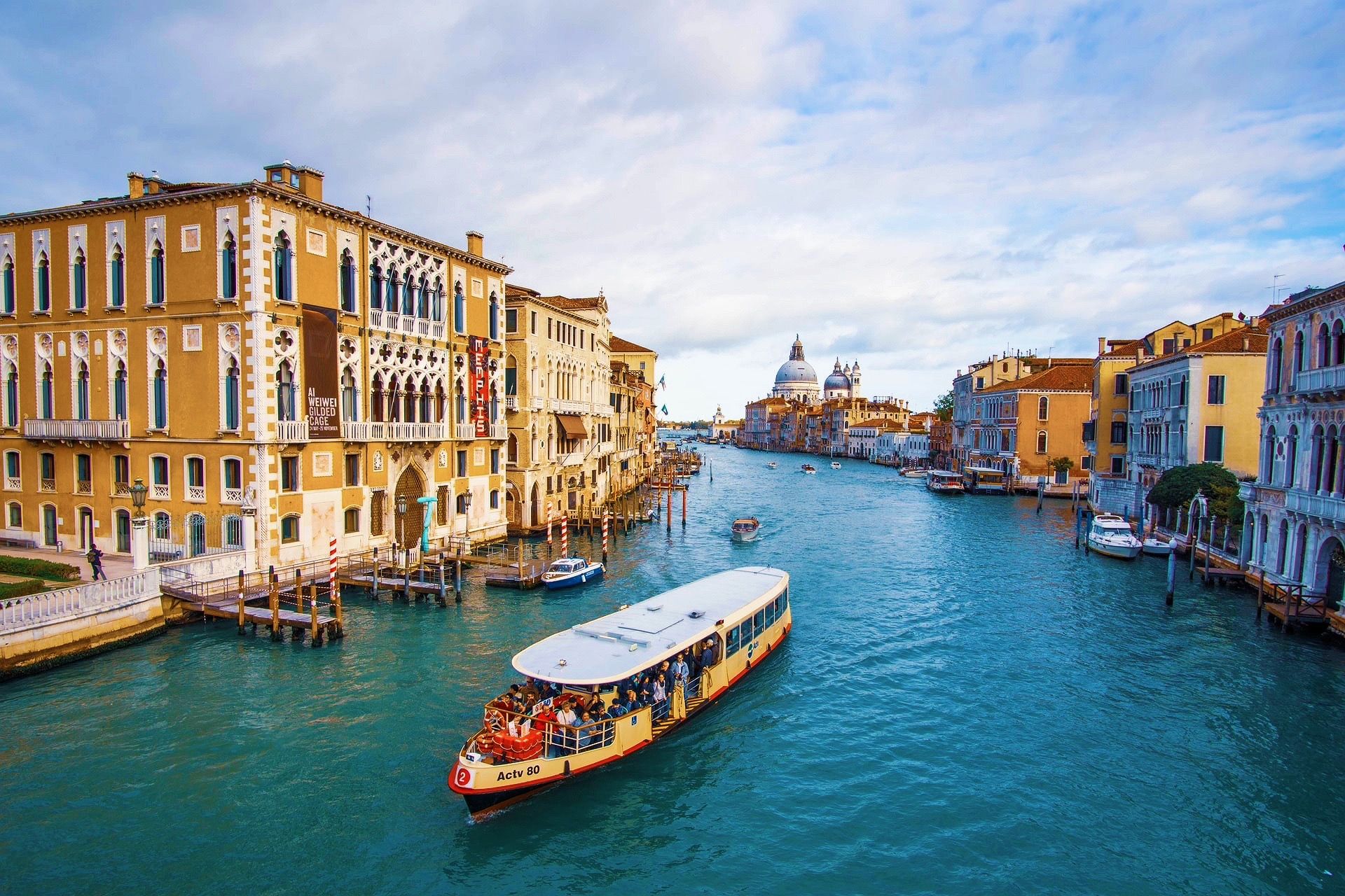 Passenger boat travels along Venice's Grand Canal between historic buildings