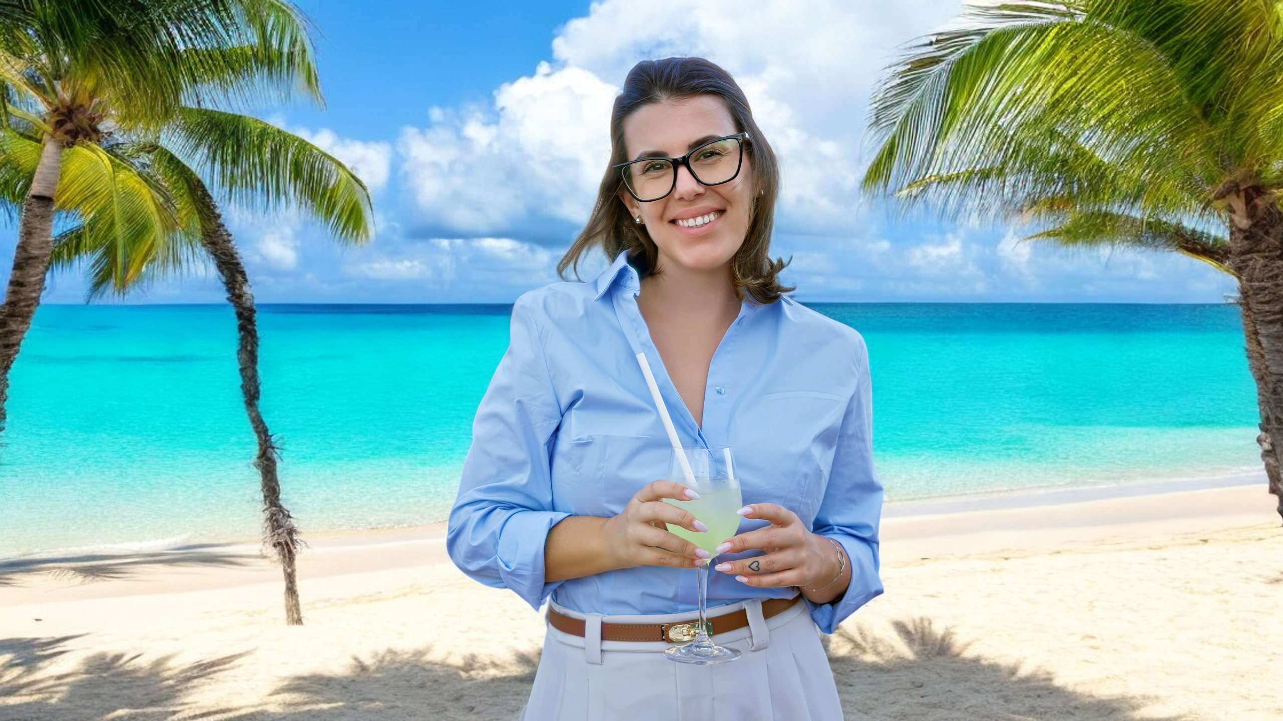 Woman holding a drink on a palm-lined tropical beach