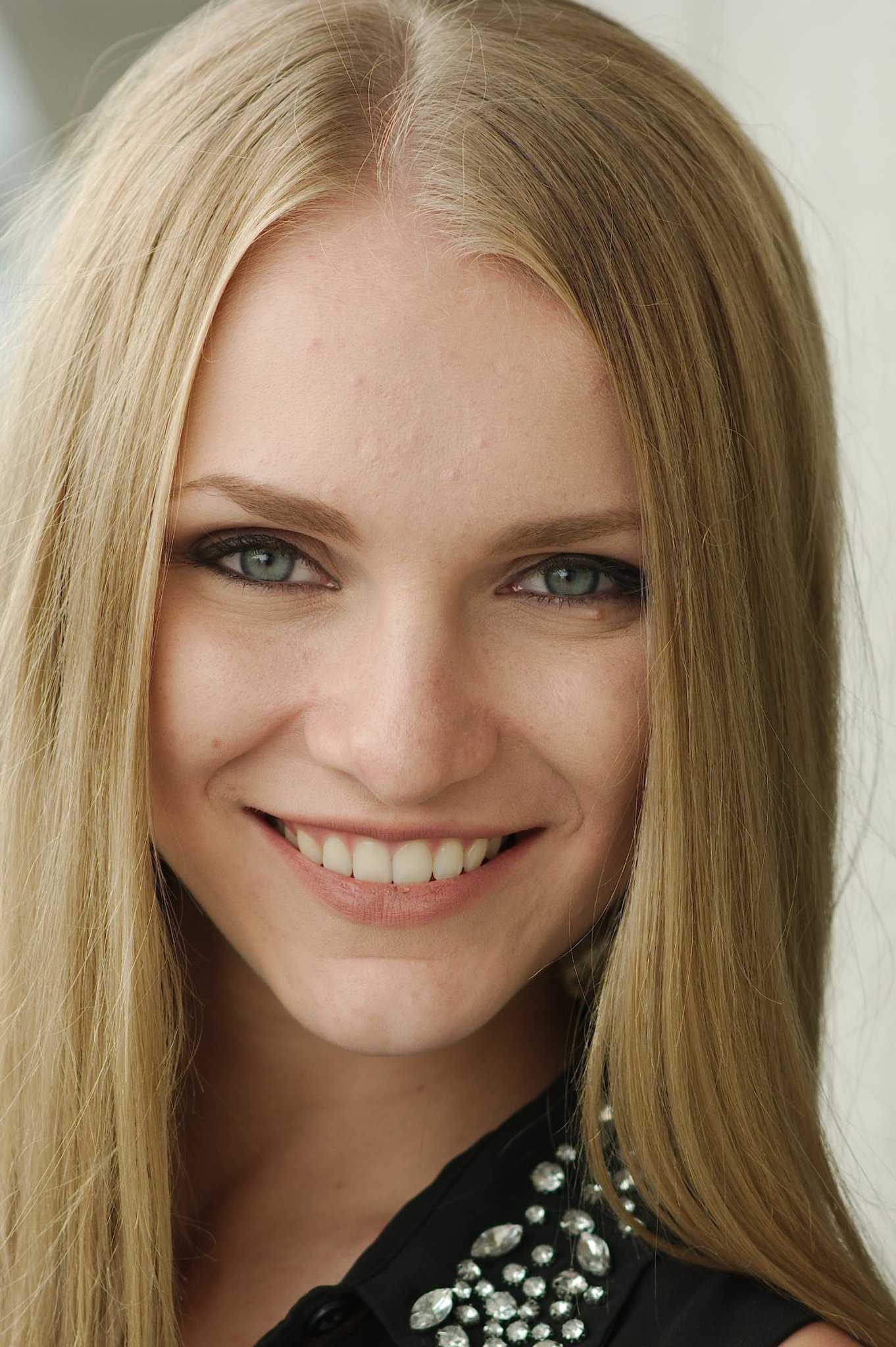 Woman with long blonde hair smiling at the camera