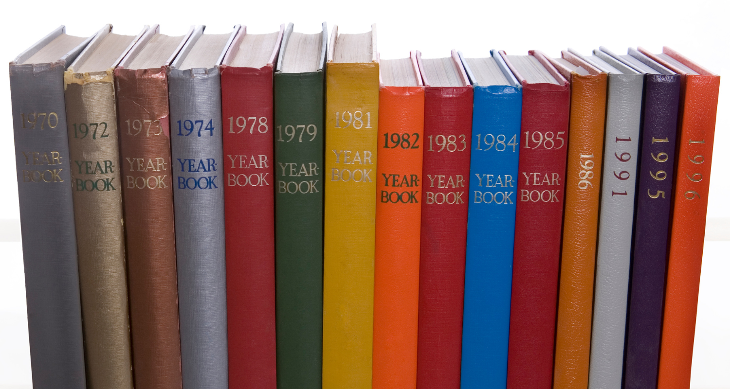 Yearbooks from 1970 through 1996 arranged upright