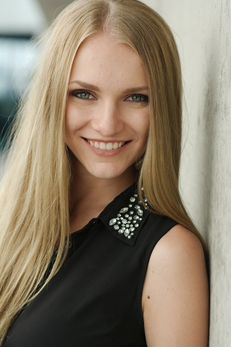 Woman with long blonde hair smiling at the camera