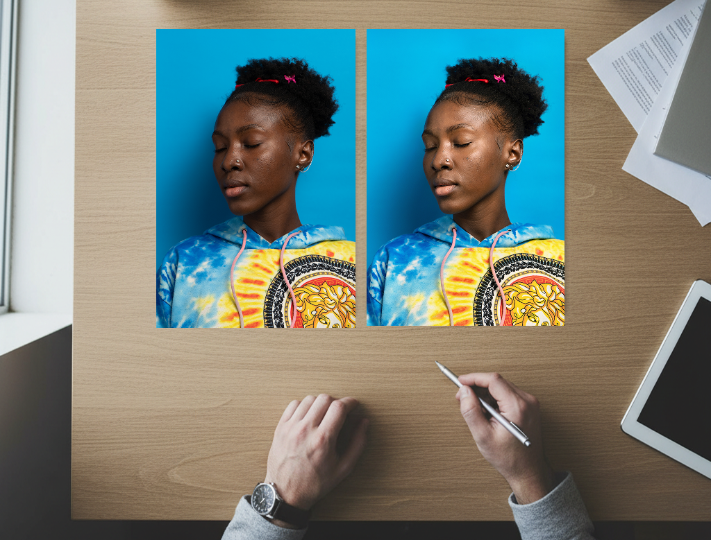 Two printed portraits of a young woman compared side by side on a desk