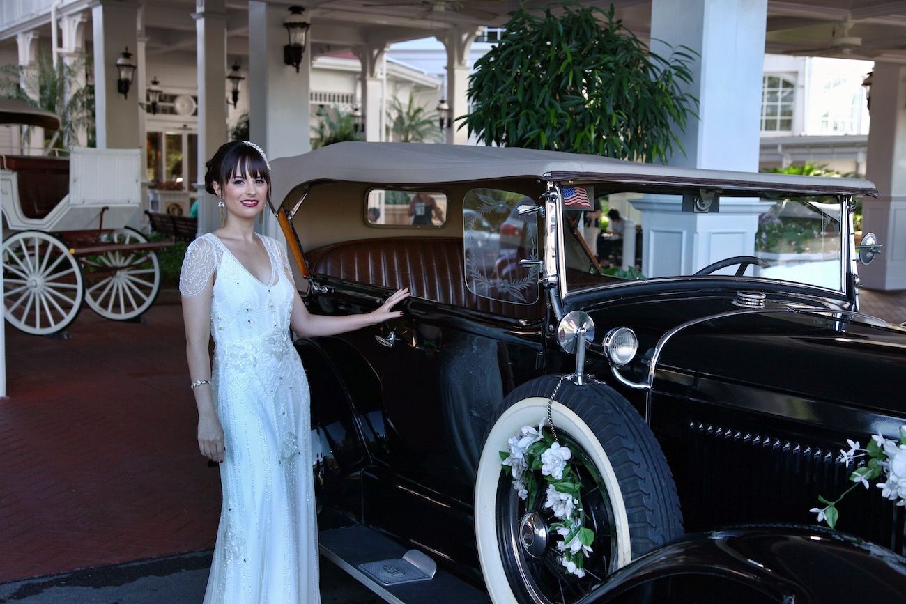 Bride beside a vintage black car after tint removal