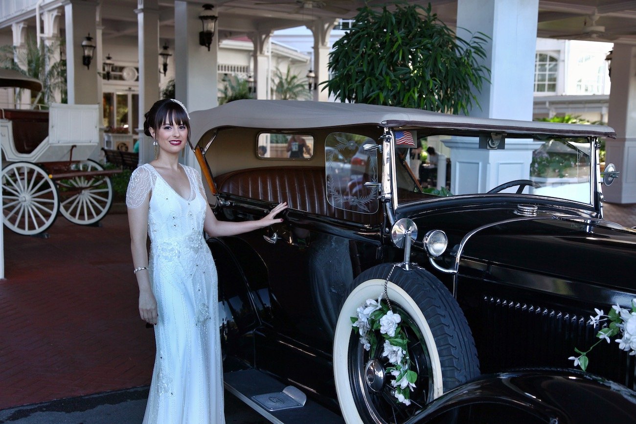 Bride beside a vintage black car after tint removal
