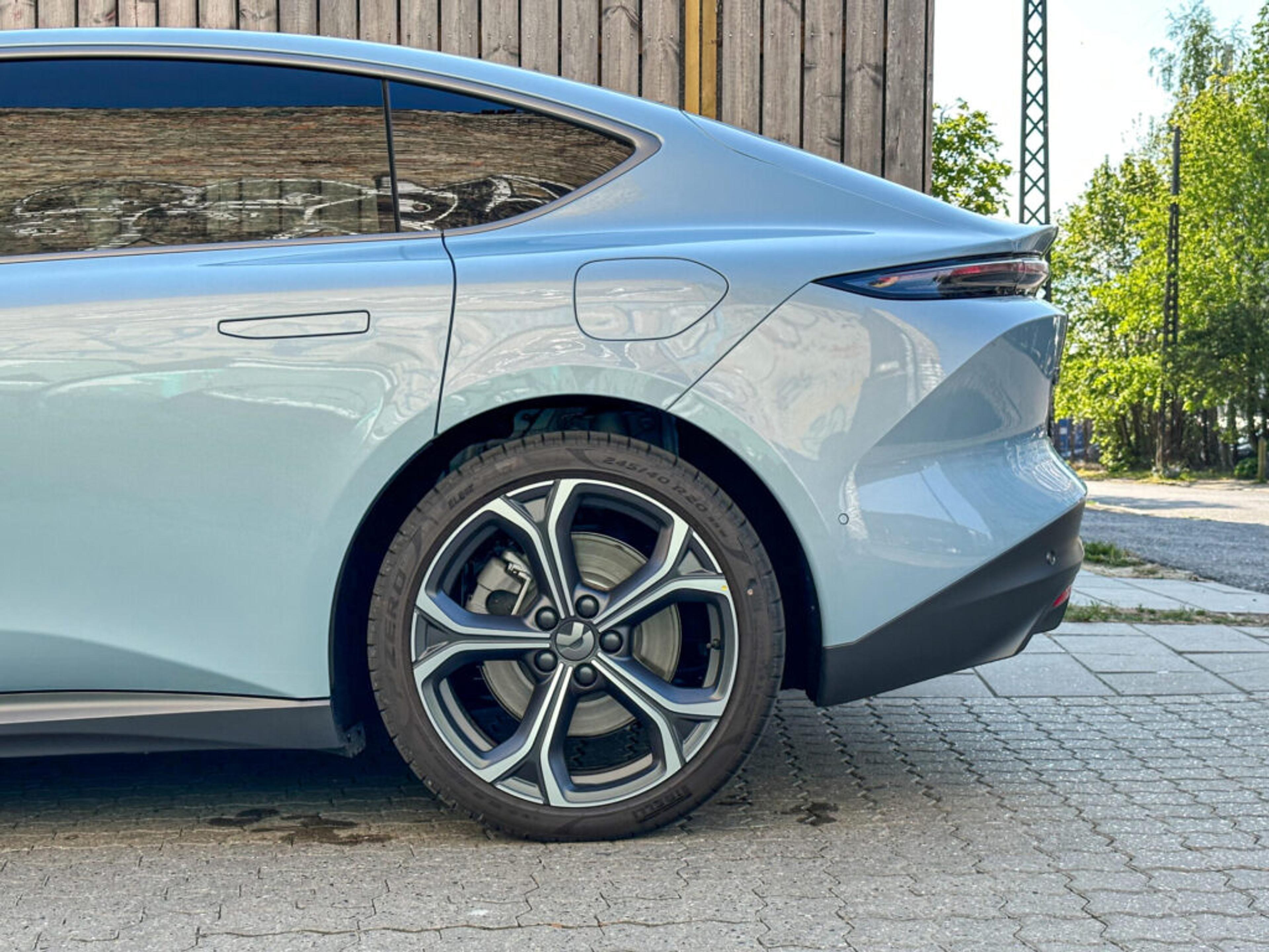 NIO's ET5 from the side, showcasing the wheel and back left side of the car