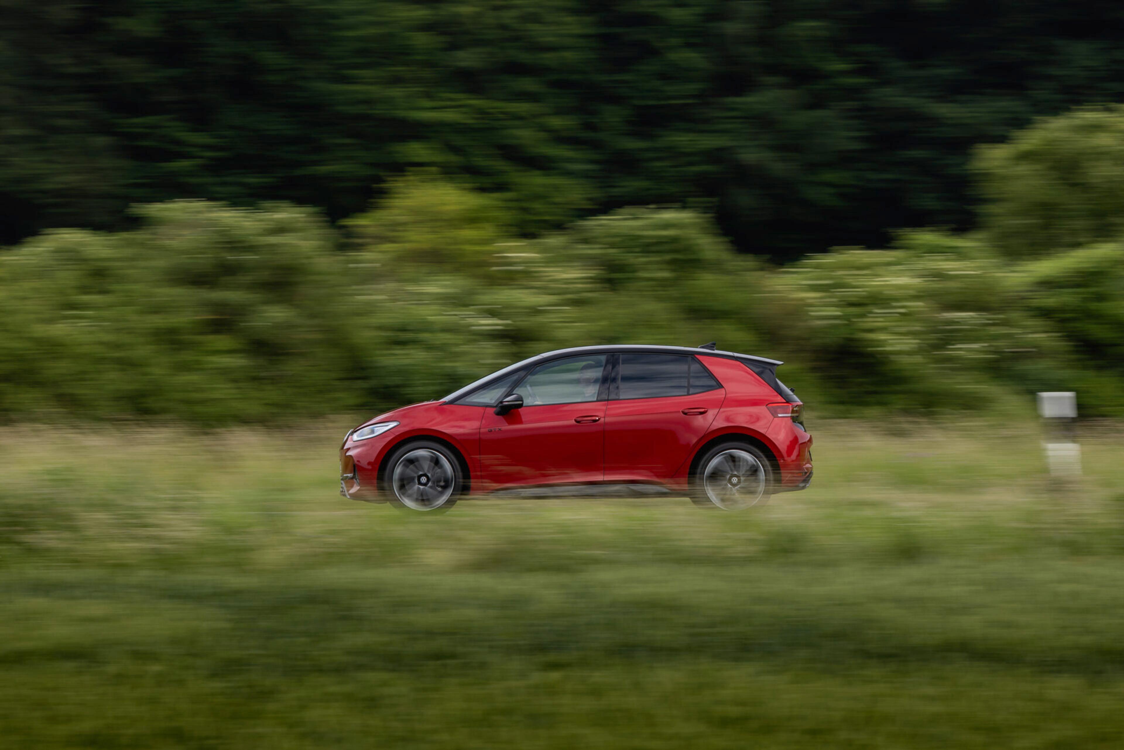 Photo of a Volkswagen EV, ID.3, in motion in red color