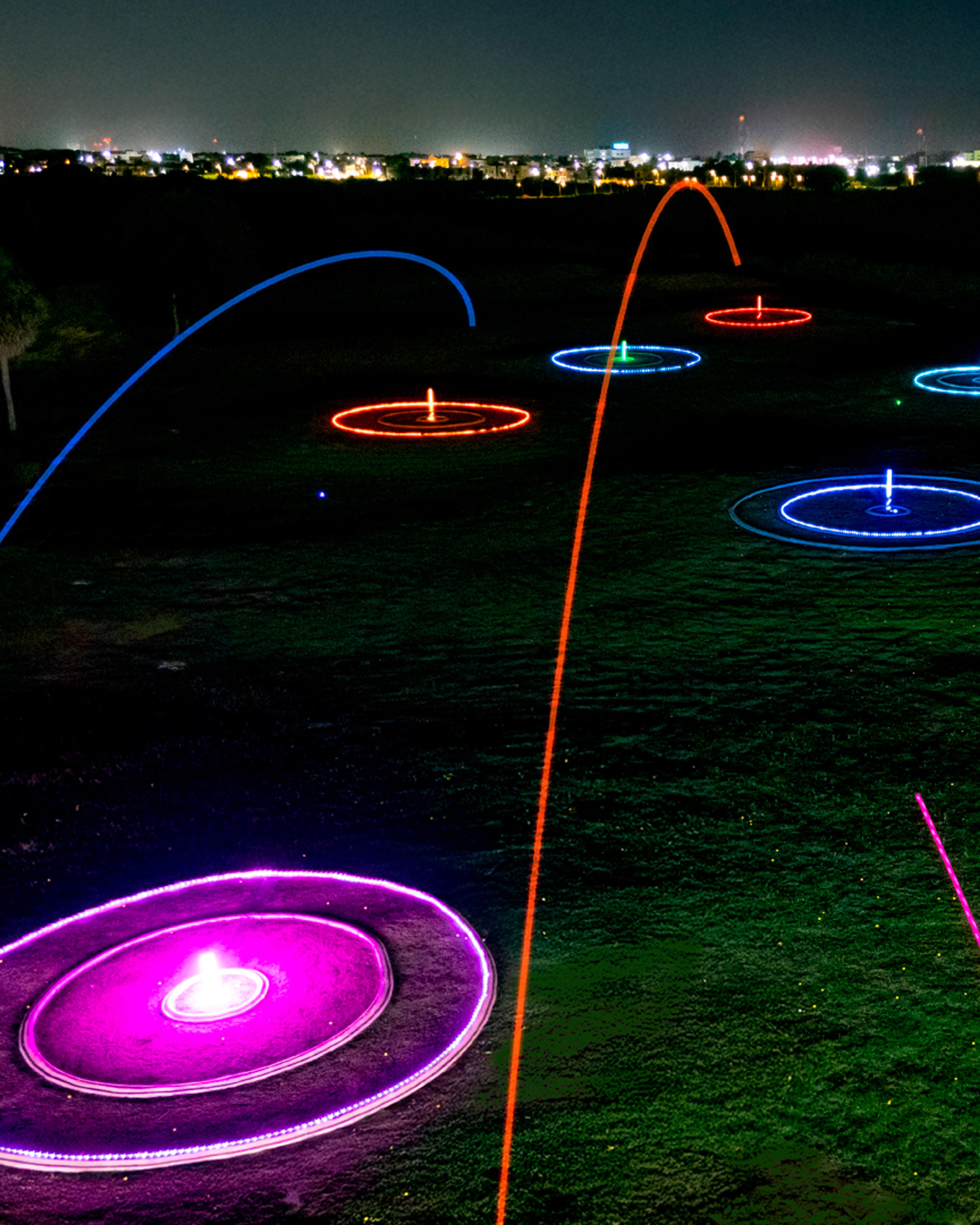 Glow-in-the-dark golf balls and bay at Golf N Shots Punta Cana at night