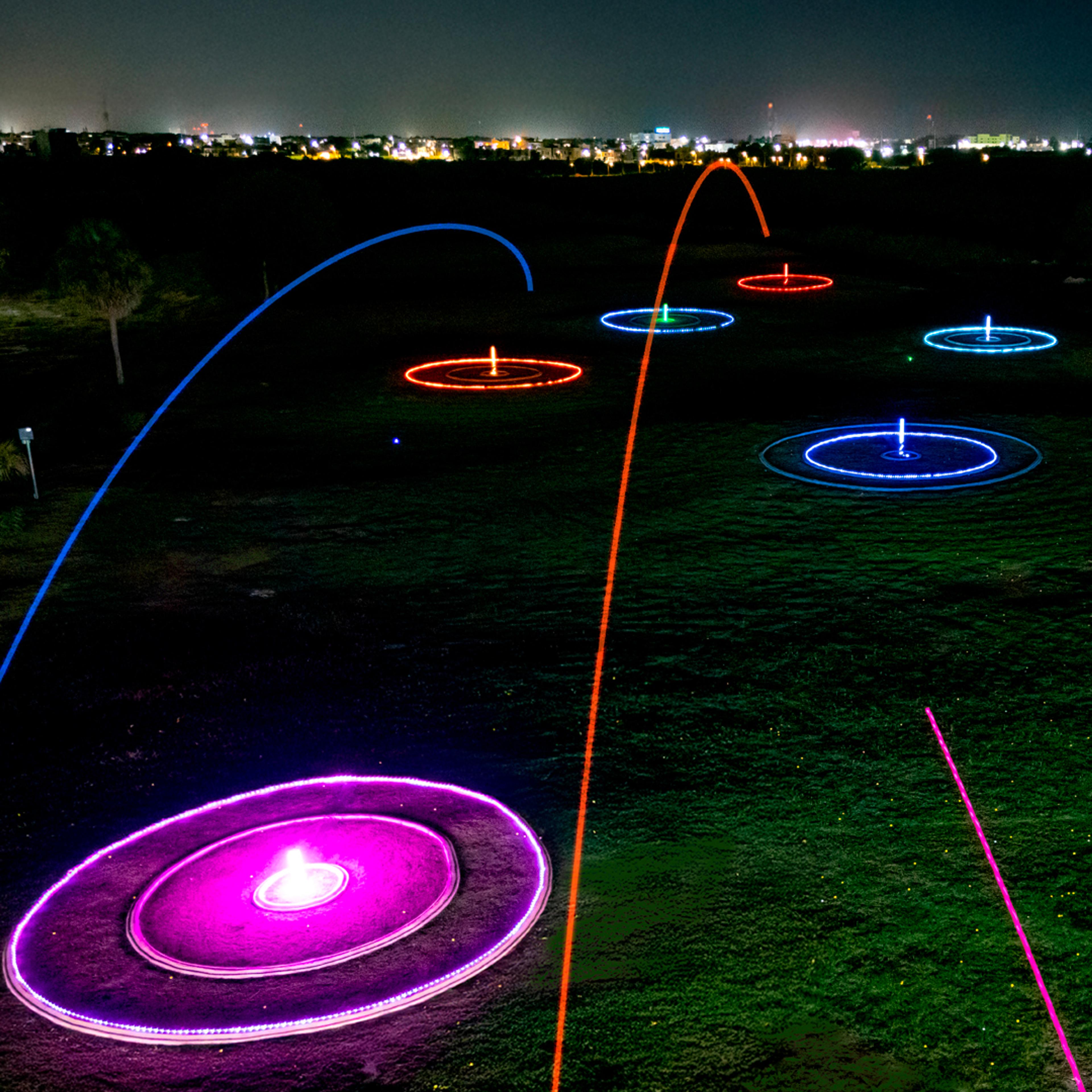Glow-in-the-dark golf balls and bay at Golf N Shots Punta Cana at night