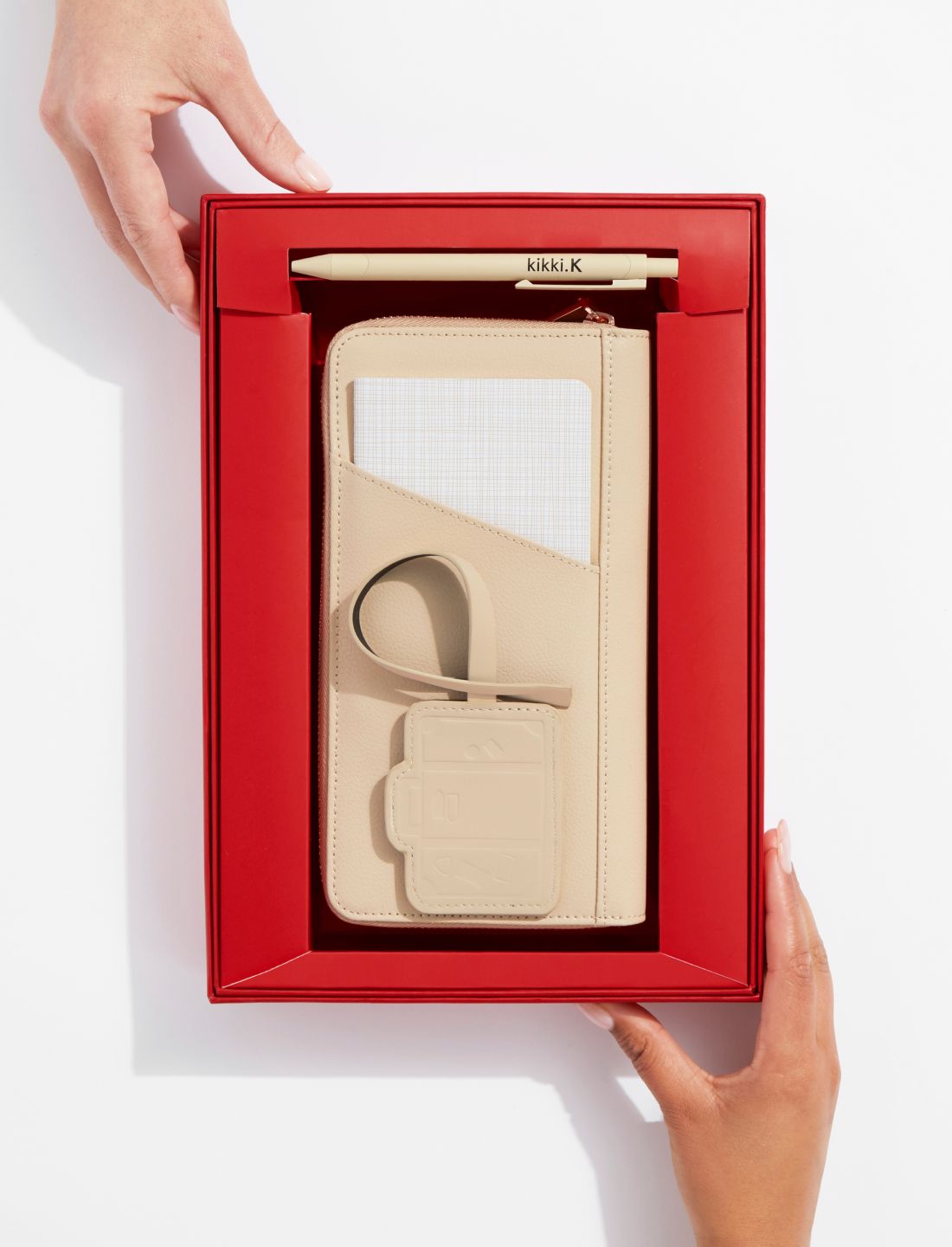 A Hand Holding A Box Of Gifts