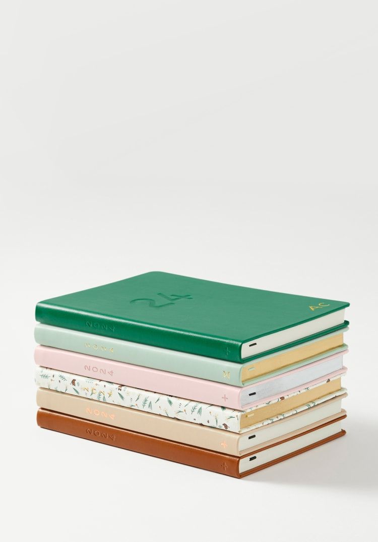 a stack of books on a white surface