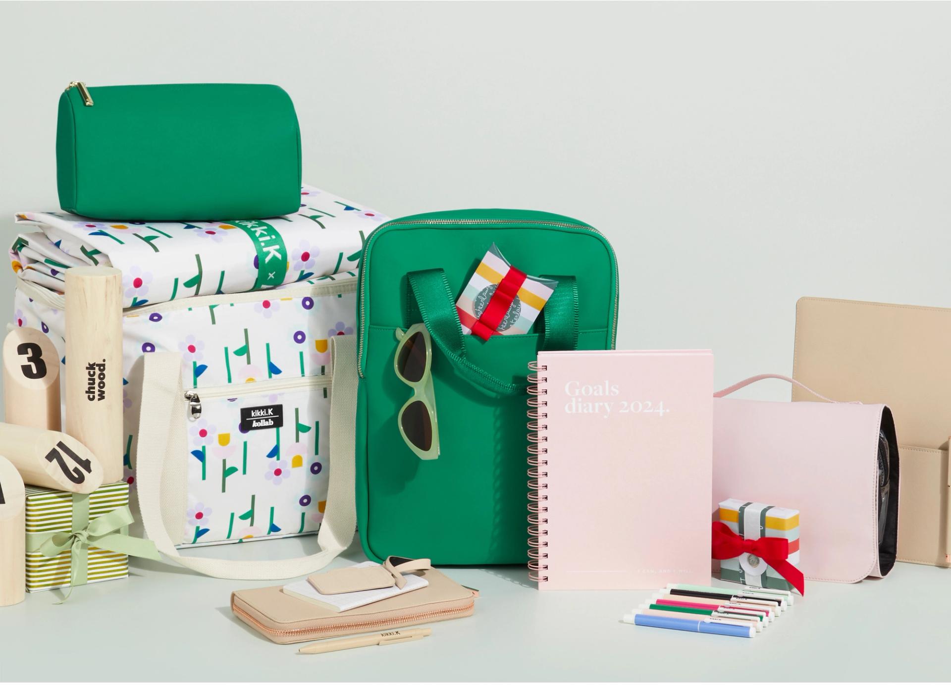 a group of green and white bags and a notebook